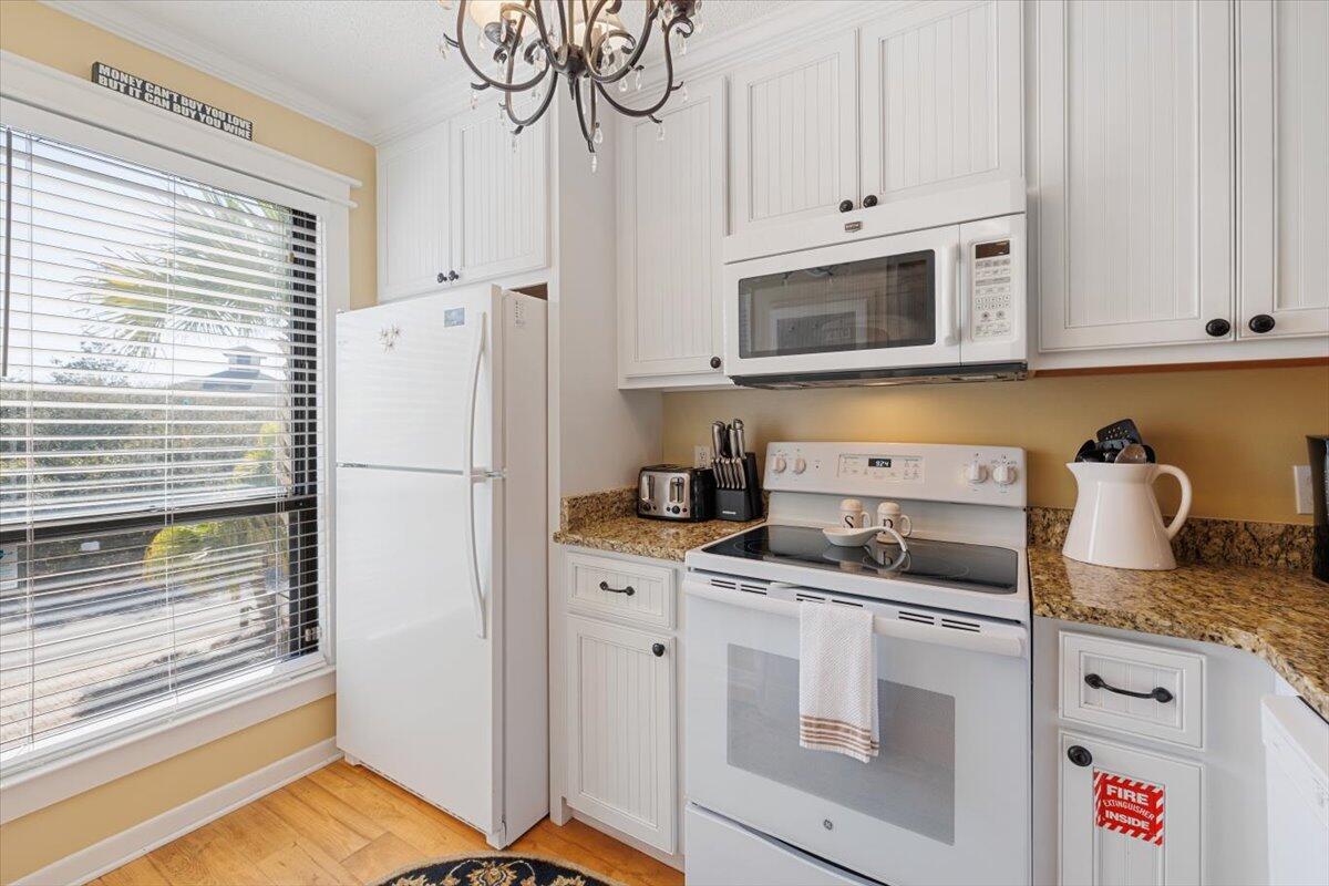 255 Pelican Circle, Unit 3 Inlet Beach, FL 32461 - Photo 10 of 38 a kitchen with stainless steel appliances granite countertop a refrigerator and a stove top oven