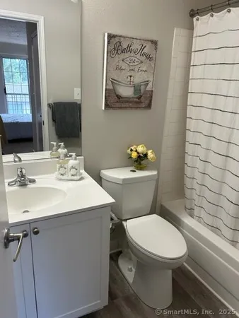 a bathroom with a sink mirror and toilet