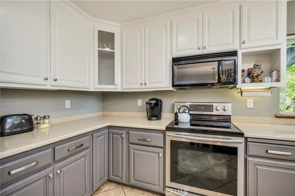 a kitchen with cabinets stainless steel appliances and a sink