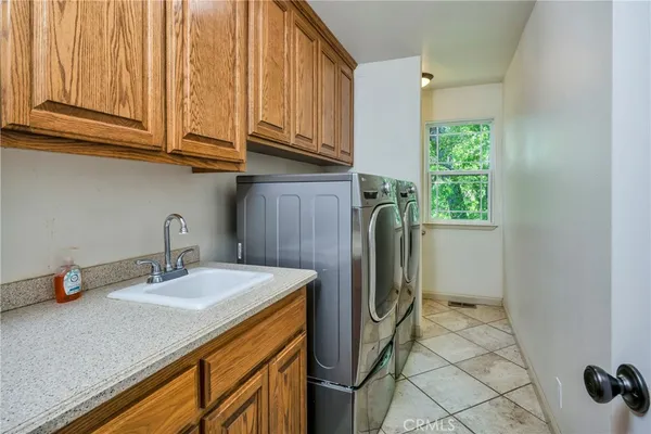 a bathroom with a sink a toilet and a window