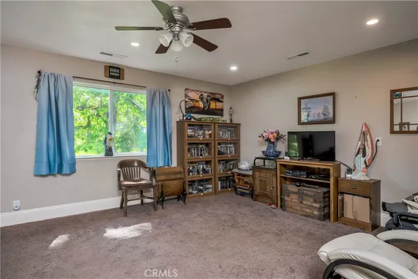 a bed sitting in a spacious bedroom next to a window