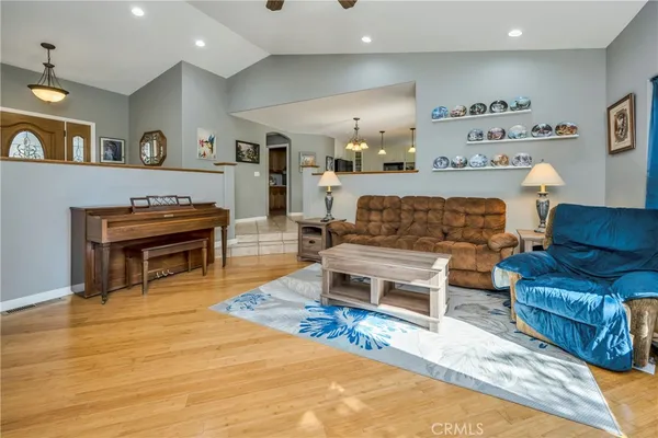 a living room with furniture and a piano