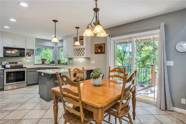 a dining room with furniture a chandelier and a rug