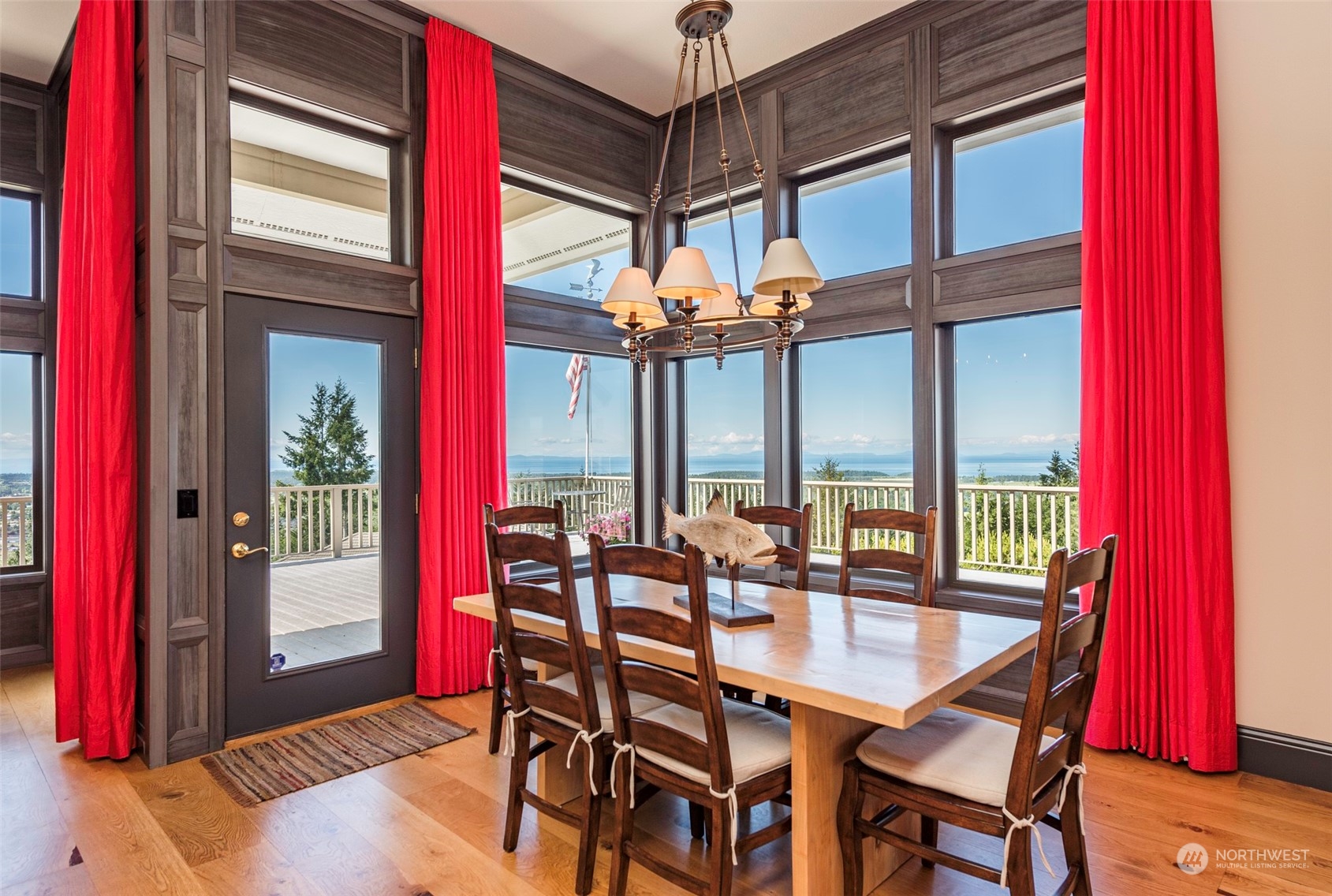 82 Owls Nest Road Sequim, WA 98382 - Photo 12 of 40 a dining room with furniture a chandelier and wooden floor