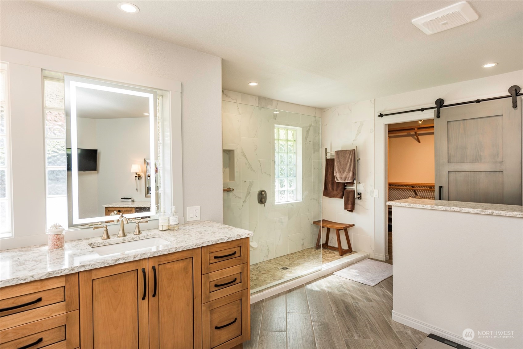 82 Owls Nest Road Sequim, WA 98382 - Photo 18 of 40 a spacious bathroom with a double vanity sink a mirror and a shower