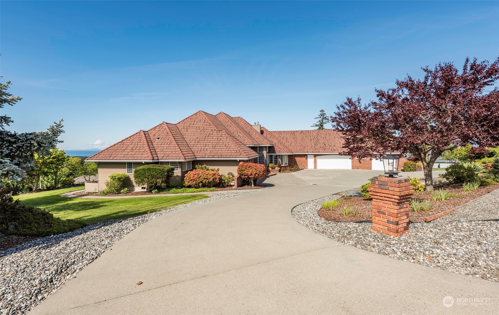 82 Owls Nest Road Sequim, WA 98382 - Photo 34 of 40 a front view of a house with a yard and garage