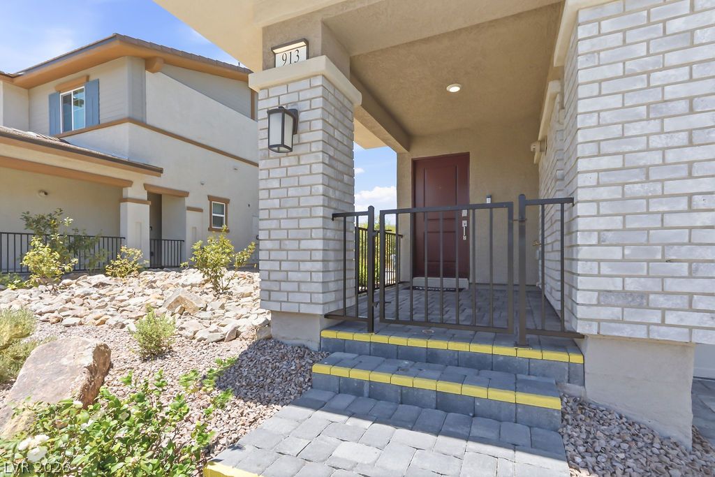 913 Cadence View Way Henderson, NV 89011 - Photo 8 of 46 A welcoming brick entryway with pavers and steps leads to this charming residence.