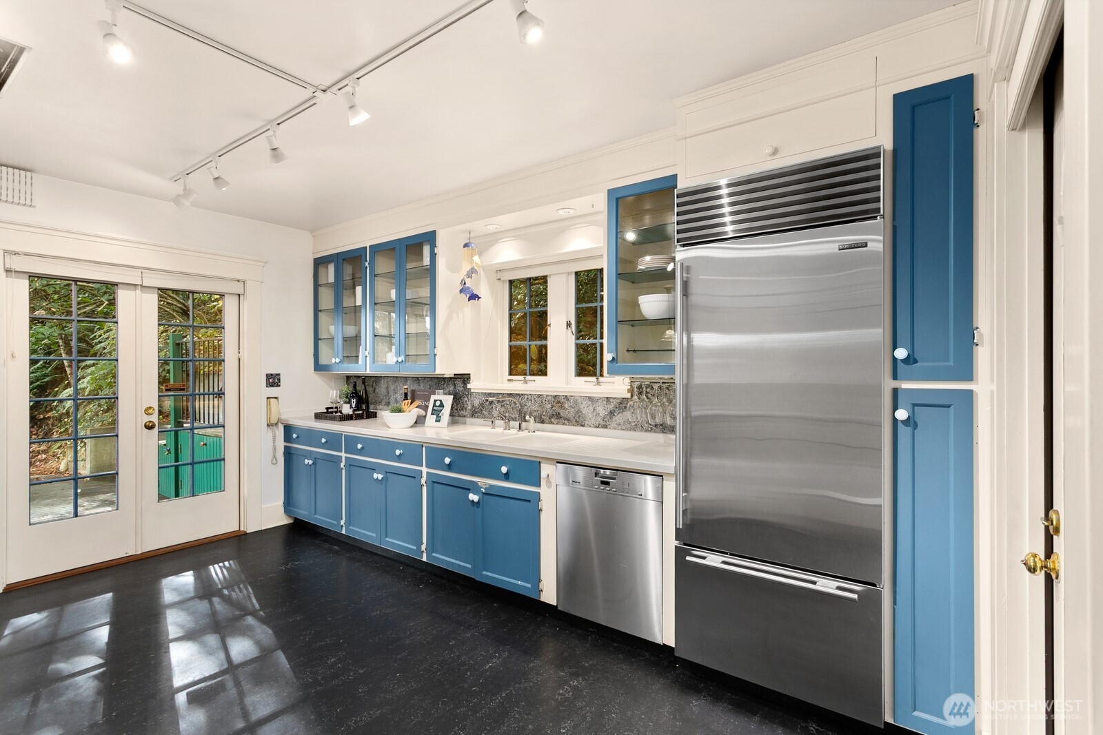 615 36th Avenue Seattle, WA 98122 - Photo 13 of 40 a kitchen with stainless steel appliances granite countertop a refrigerator and a sink