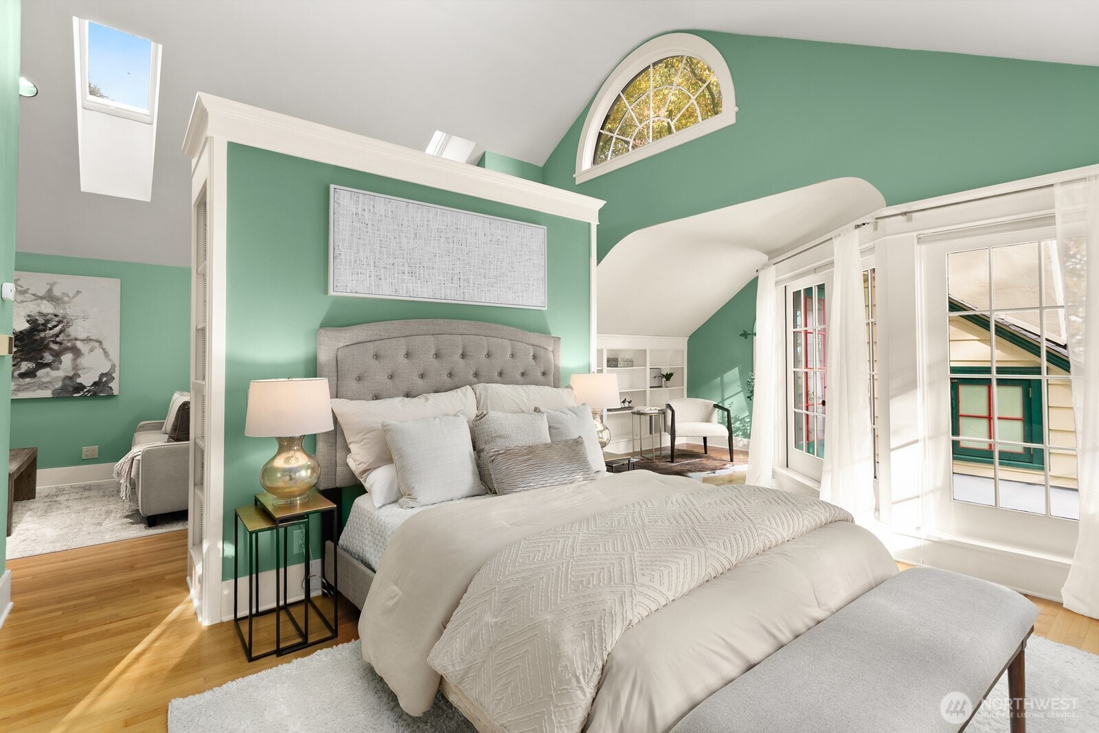 615 36th Avenue Seattle, WA 98122 - Photo 27 of 40 a bedroom with a bed window and a chandelier