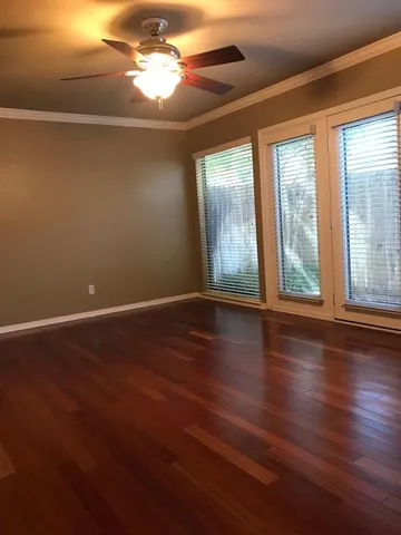 a view of room with window and wooden floor