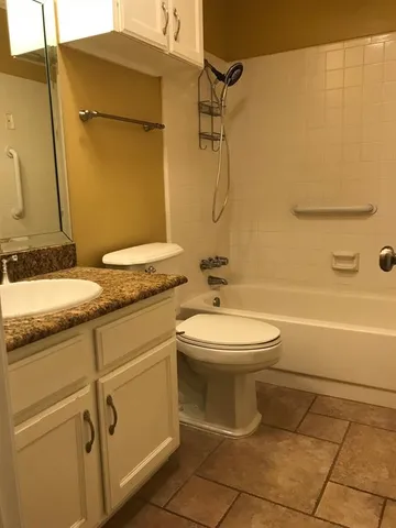 a bathroom with a toilet sink and shower