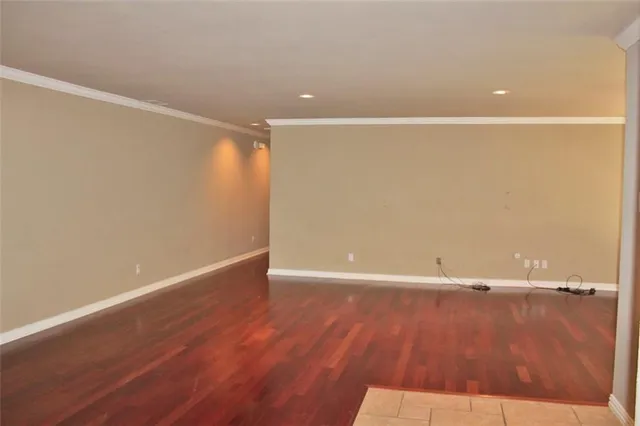 a view of a room with wooden floor