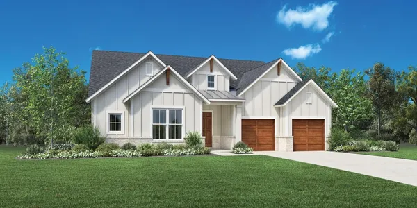 a front view of a house with a garden and yard