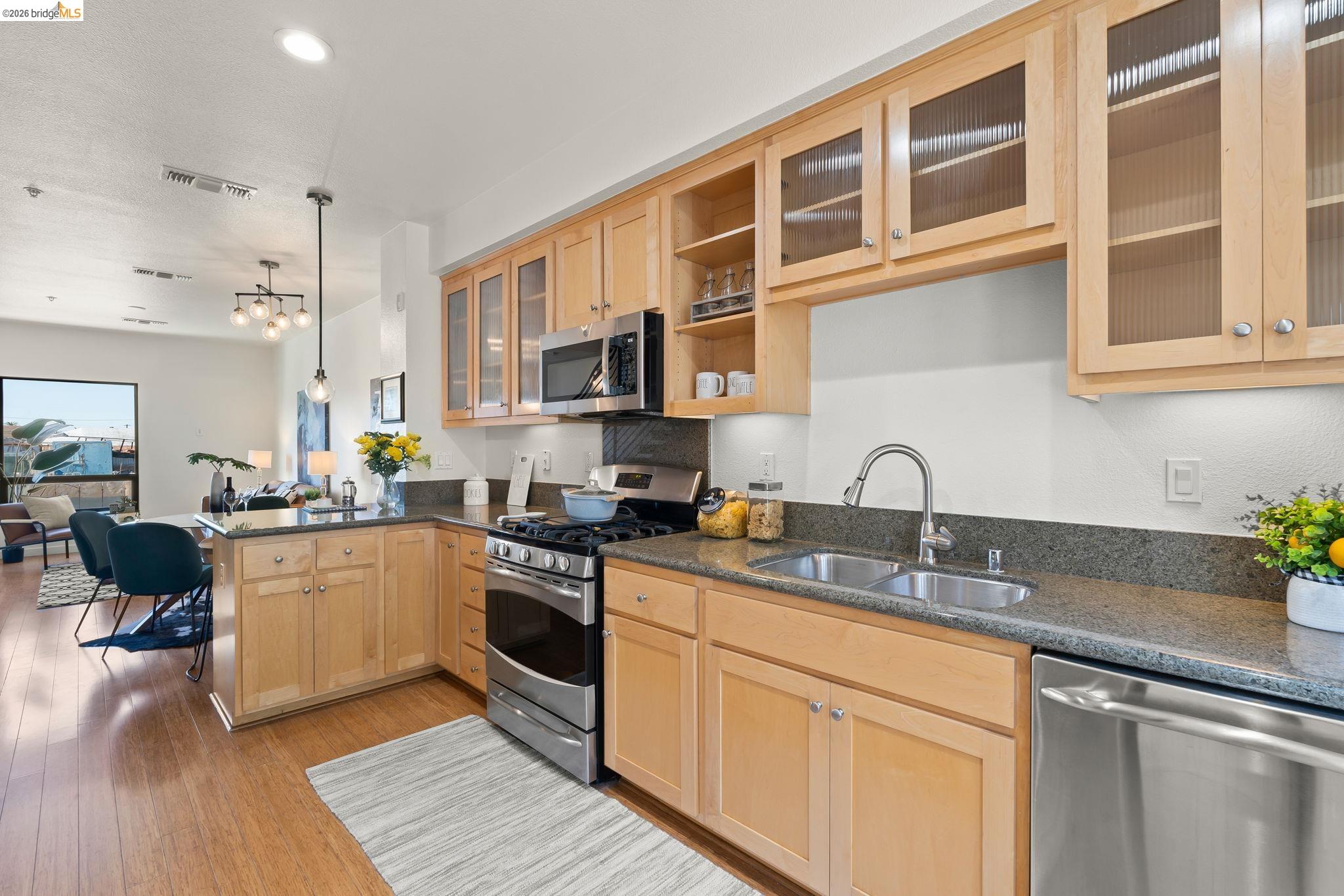 1780 12th Street Oakland, CA 94607 - Photo 9 of 31 a kitchen with a sink stove and cabinets