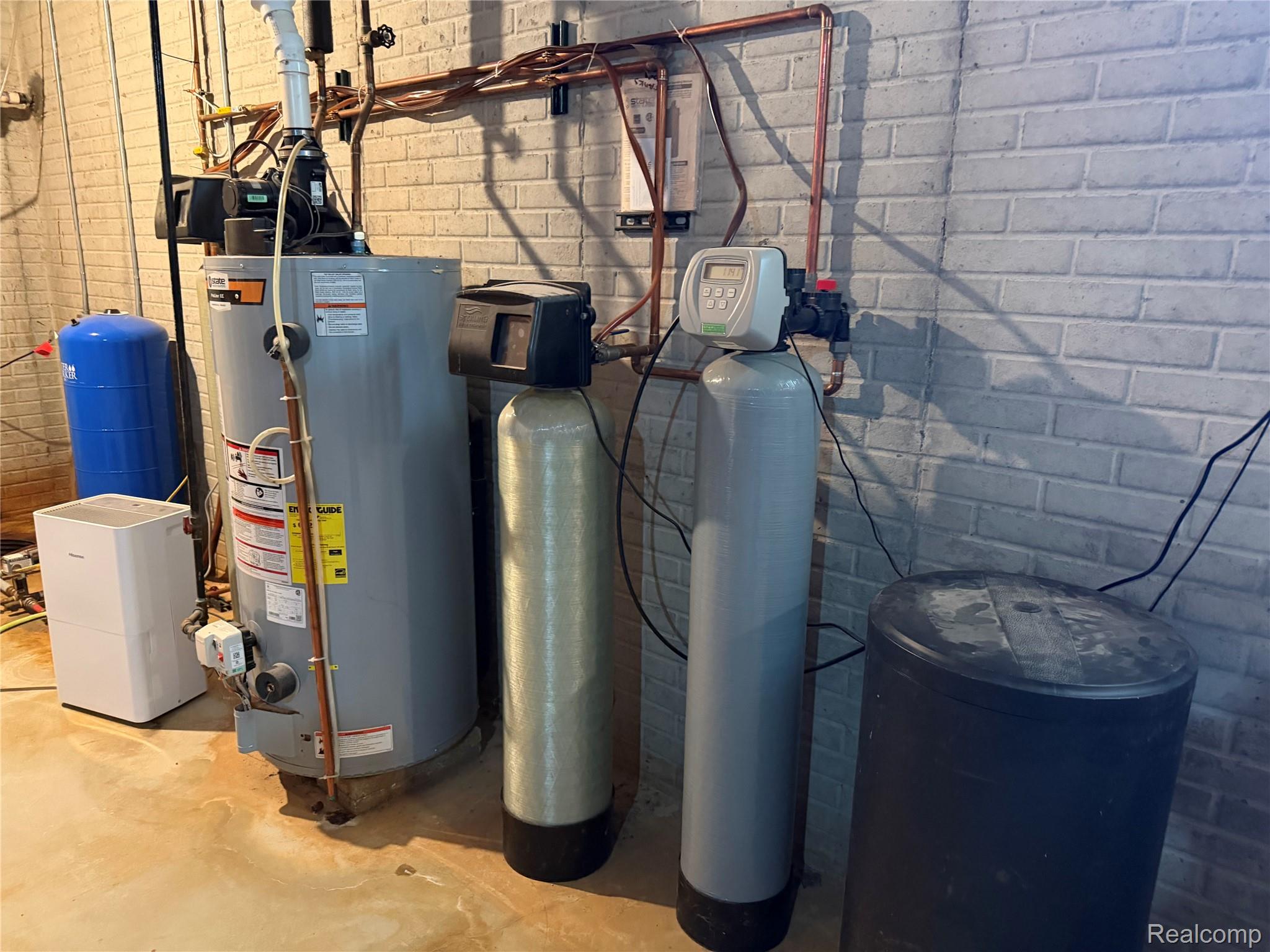 6860 Grand River Road Bancroft, MI 48414 - Photo 18 of 31 Utility room featuring gas water heater