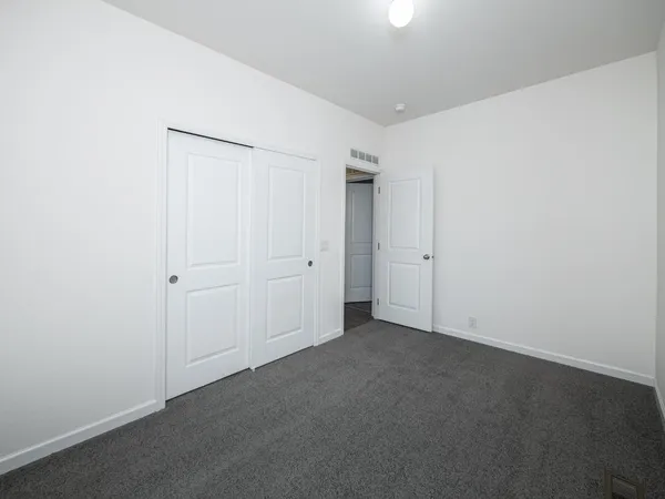 a bathroom with a granite countertop sink a toilet a mirror and bathtub