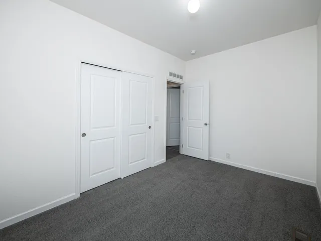 a bathroom with a granite countertop sink a toilet a mirror and bathtub
