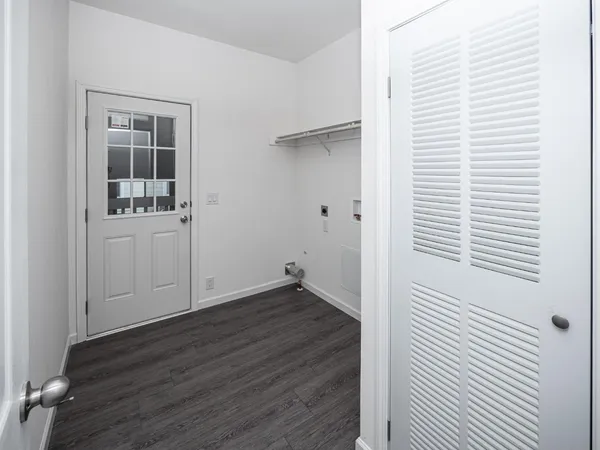 a view of a room with wooden floor