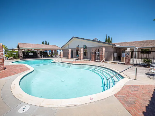 a view of a swimming pool with a patio
