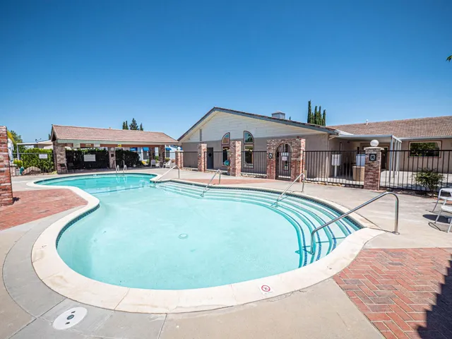 a view of a swimming pool with a patio