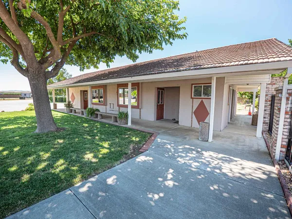 a living room with lots of furniture and a chandelier