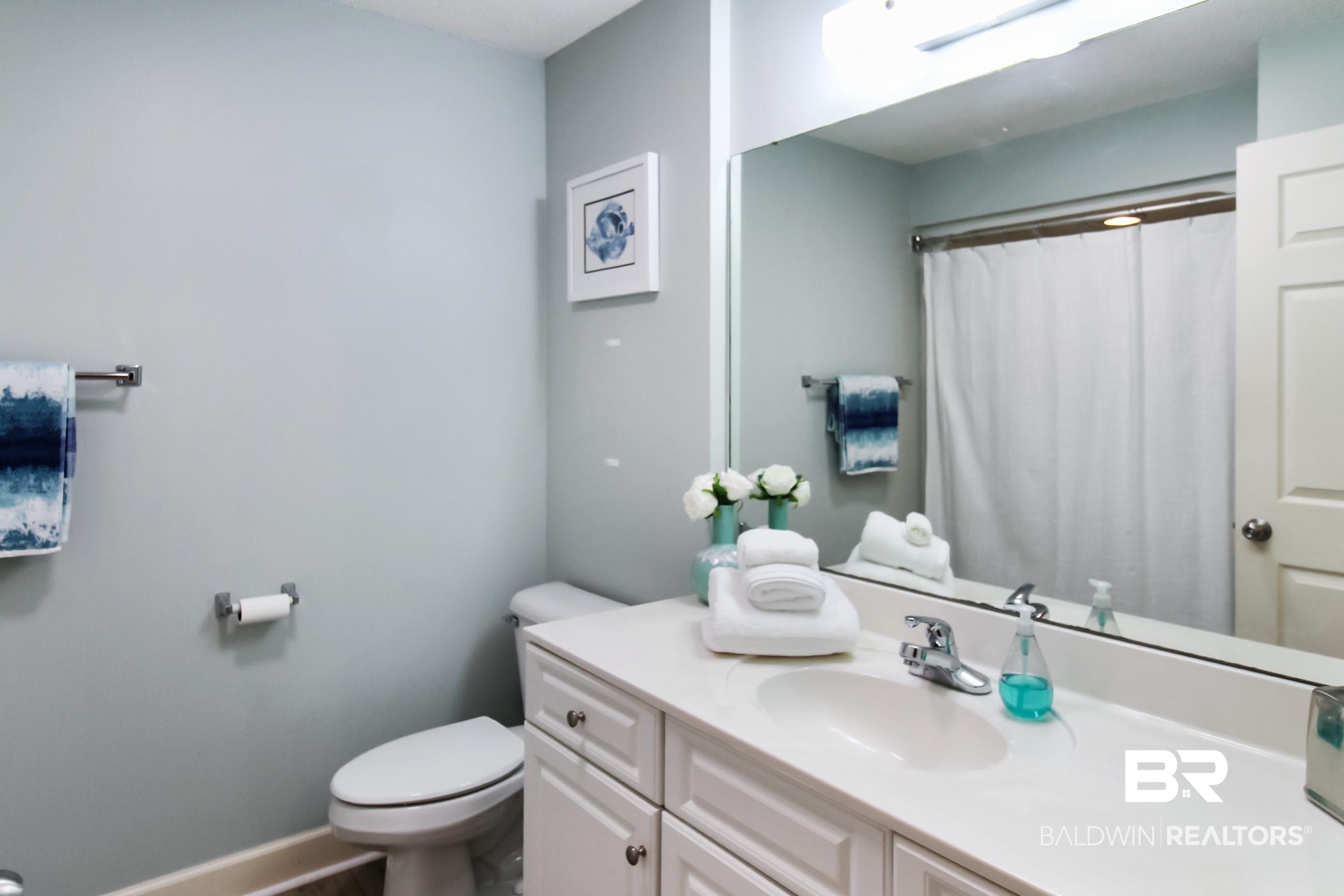 27580 Canal Road, Unit 1425 Orange Beach, AL 36561 - Photo 17 of 28 Bathroom with vanity and a shower with curtain