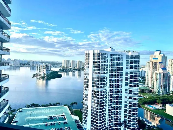 a kitchen with granite countertop a sink stove and cabinets