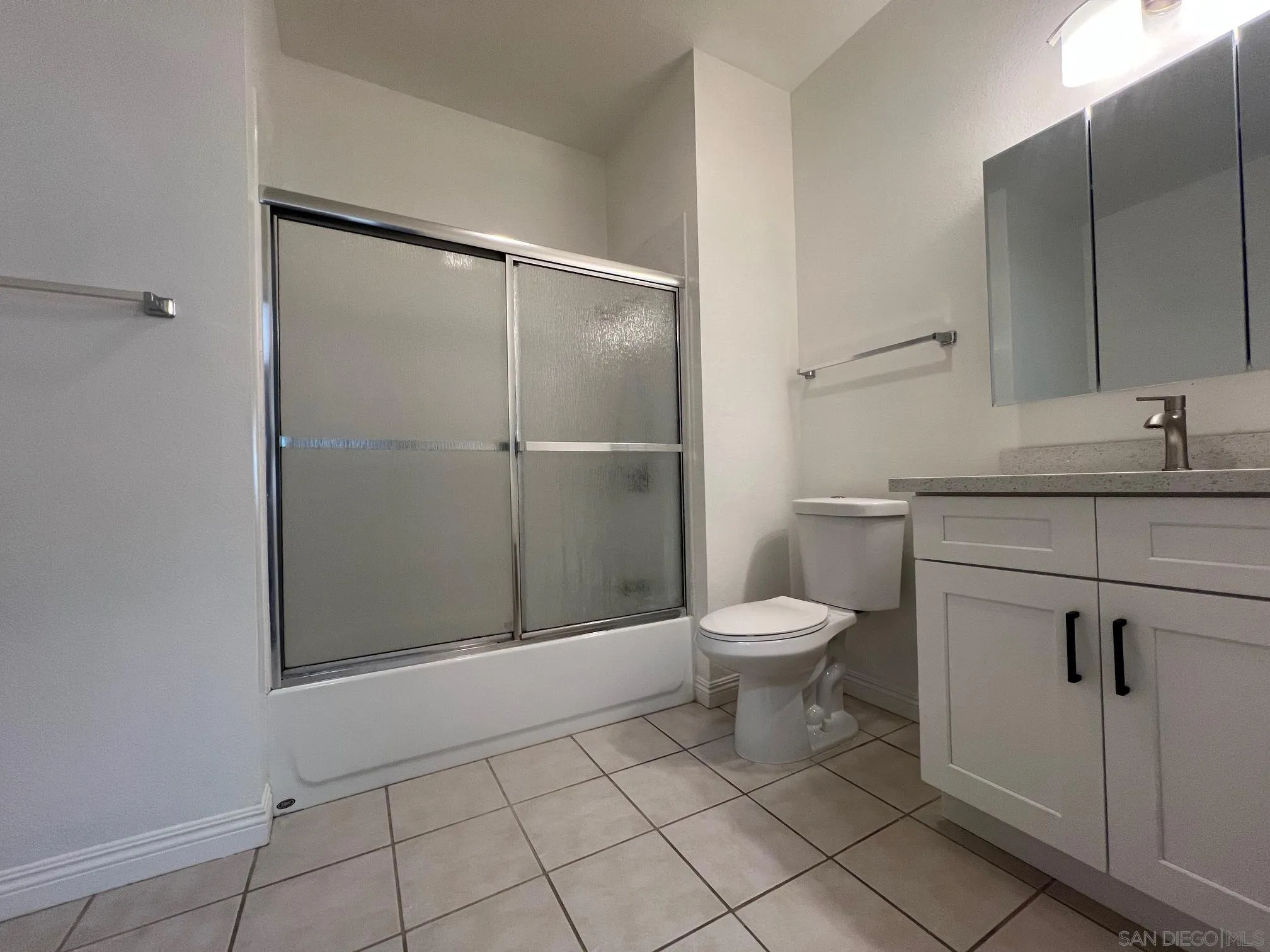 8310 Regents Road, Unit 1E San Diego, CA 92122 - Photo 15 of 23 a bathroom with a toilet a sink and shower