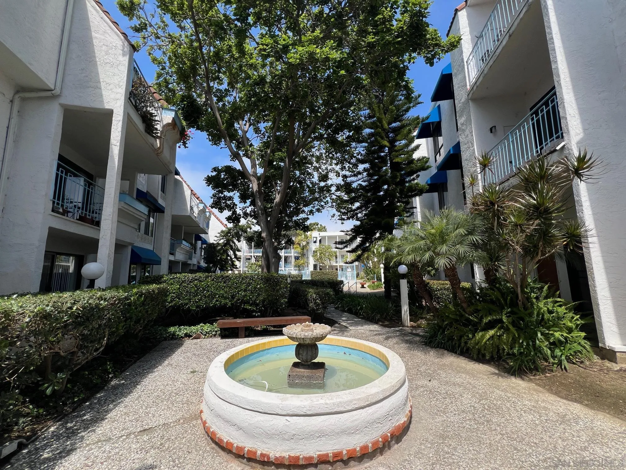 8310 Regents Road, Unit 1E San Diego, CA 92122 - Photo 22 of 23 a backyard of a house with a fountain table and chairs