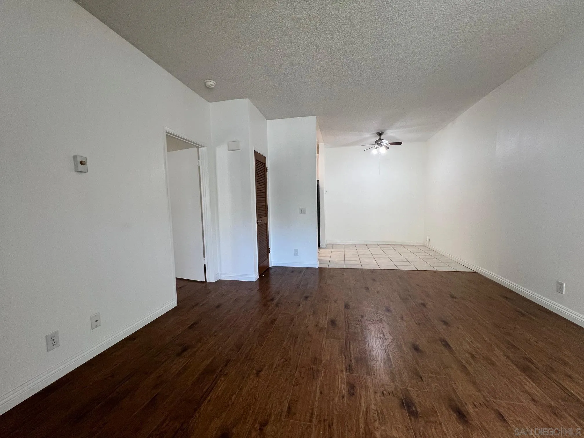 8310 Regents Road, Unit 1E San Diego, CA 92122 - Photo 6 of 23 an empty room with wooden floor