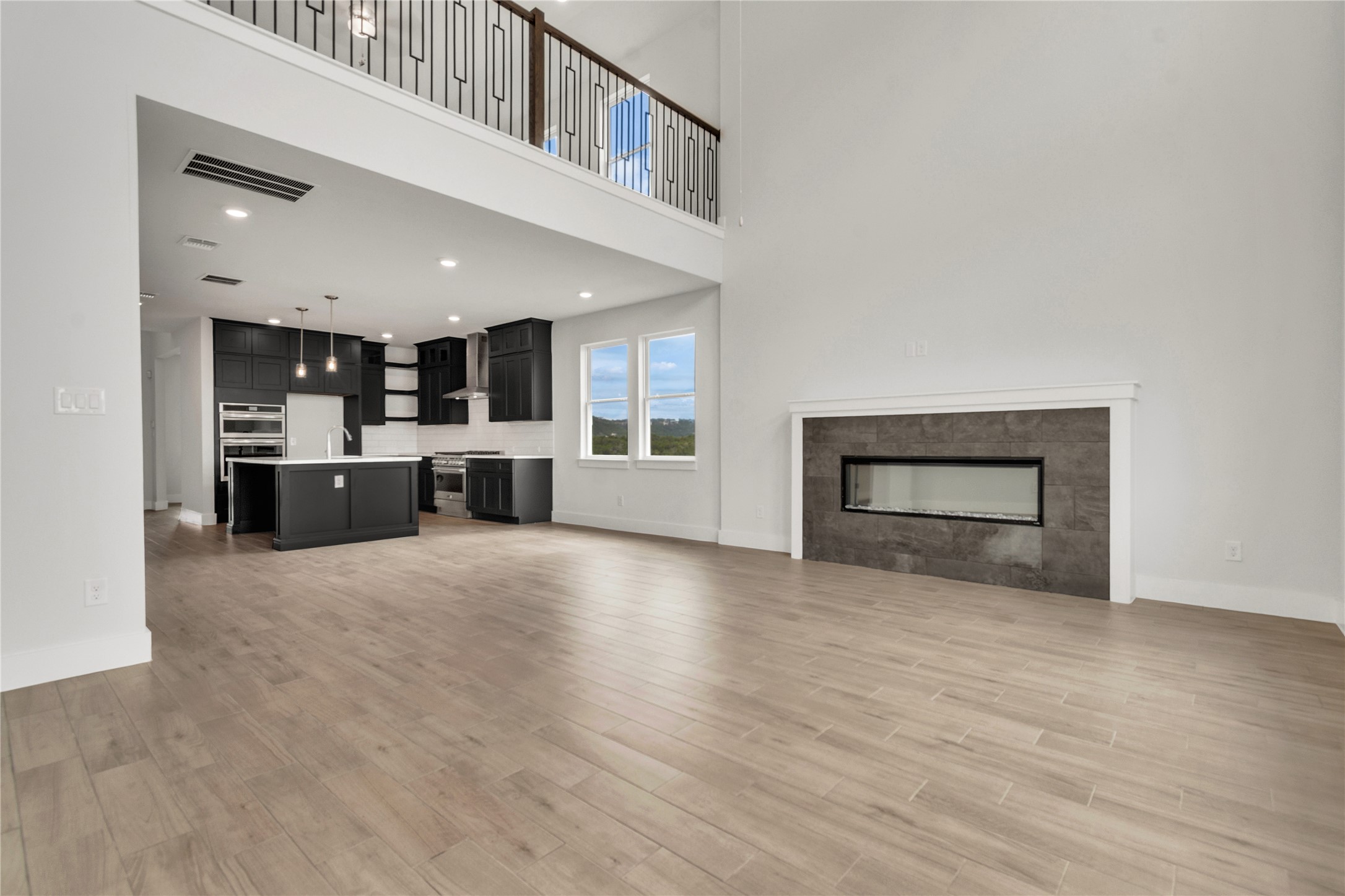 8500 Red Bottle Brush Road Lago Vista, TX 78645 - Photo 6 of 33 An open concept living area boasts a modern fireplace, ideal for entertaining guests.