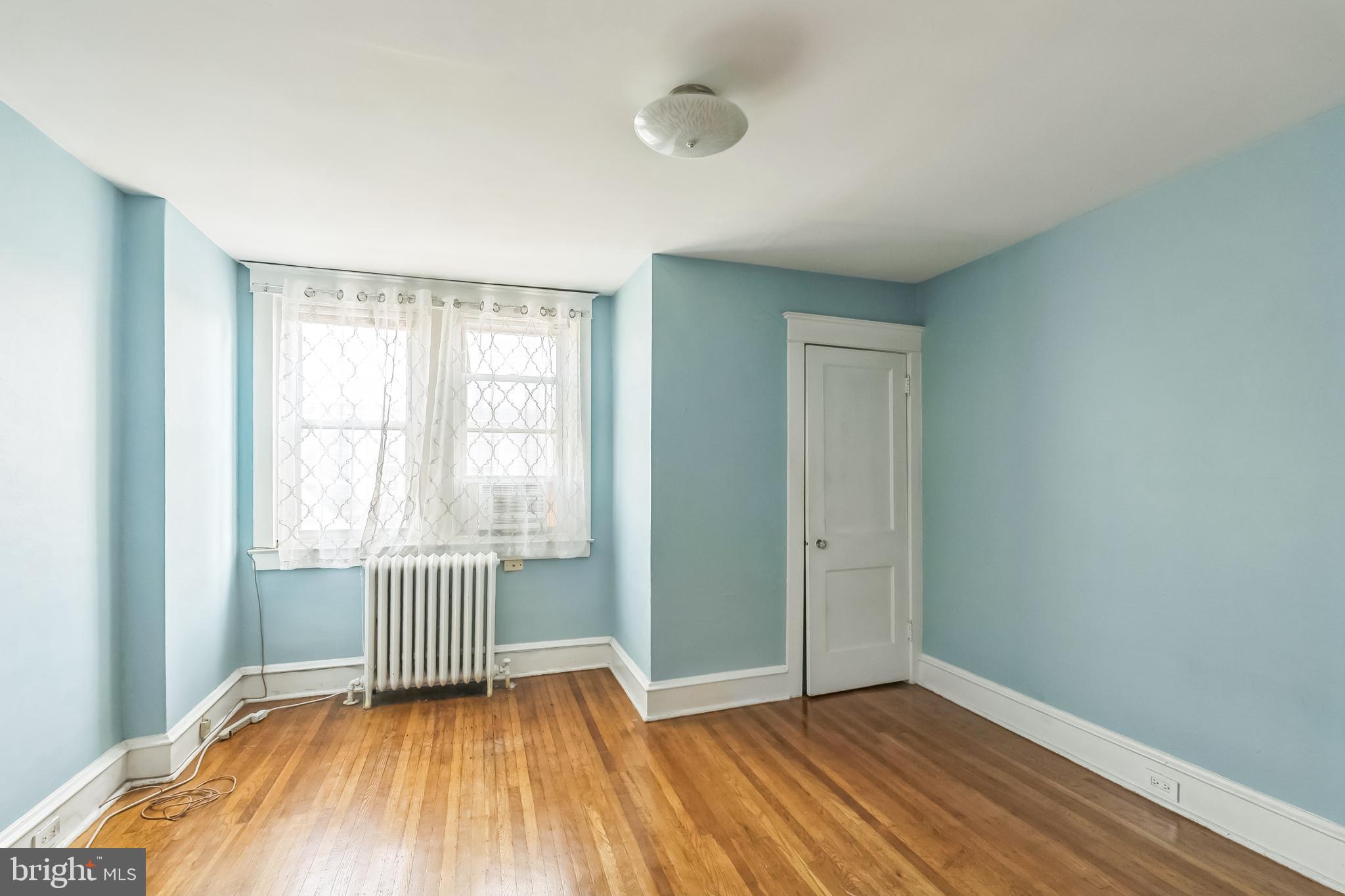 134 Heather Road Upper Darby, PA 19082 - Photo 14 of 30 an empty room with wooden floor and windows