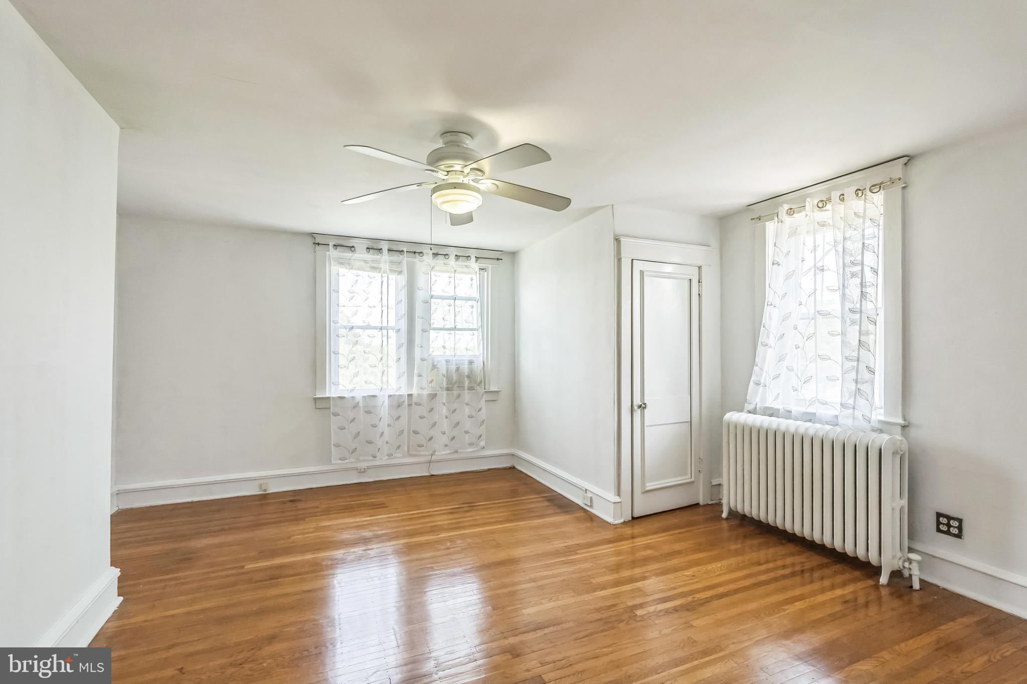 134 Heather Road Upper Darby, PA 19082 - Photo 15 of 30 wooden floor in an empty room with a window