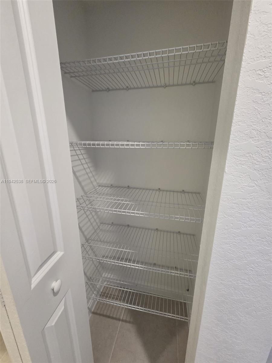 16303 Southwest 147th Place, Unit 16303 Miami, FL 33193 - Photo 12 of 37 a view of walk in closet