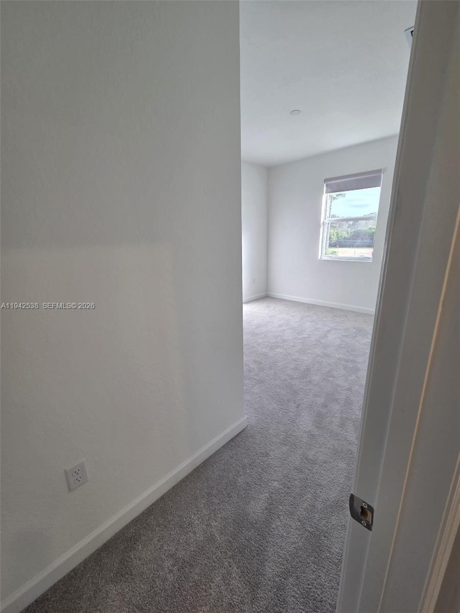 16303 Southwest 147th Place, Unit 16303 Miami, FL 33193 - Photo 15 of 37 an empty room with a window