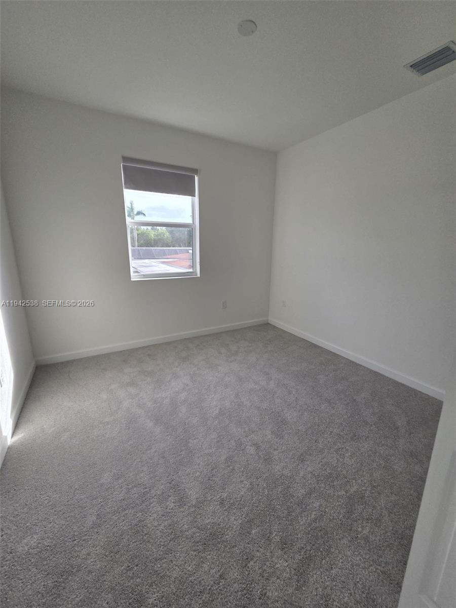 16303 Southwest 147th Place, Unit 16303 Miami, FL 33193 - Photo 17 of 37 an empty room with a window