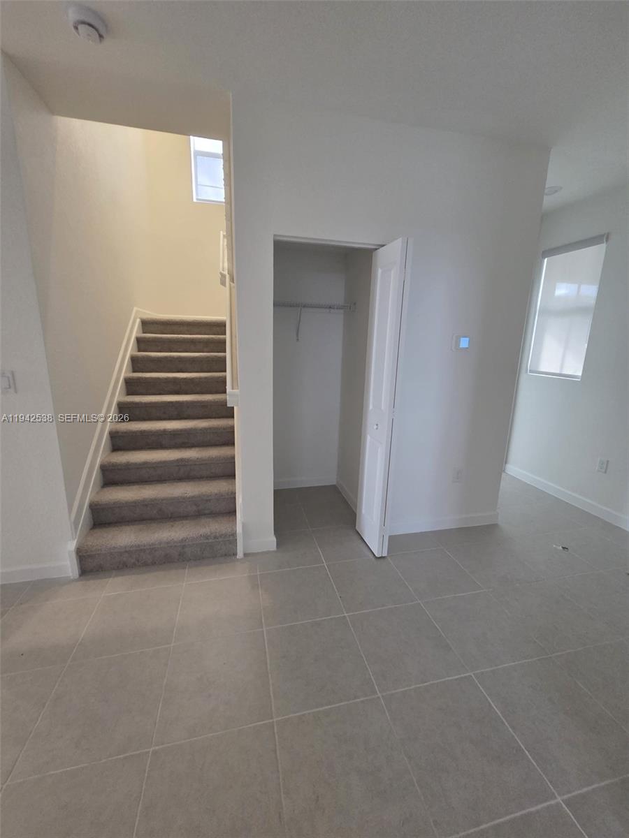16303 Southwest 147th Place, Unit 16303 Miami, FL 33193 - Photo 19 of 37 a view of an empty room with stairs