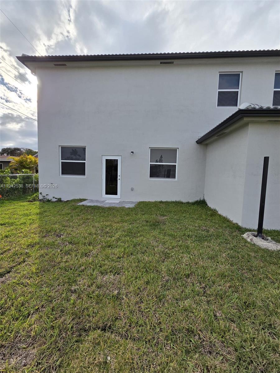 16303 Southwest 147th Place, Unit 16303 Miami, FL 33193 - Photo 20 of 37 a front view of house with yard