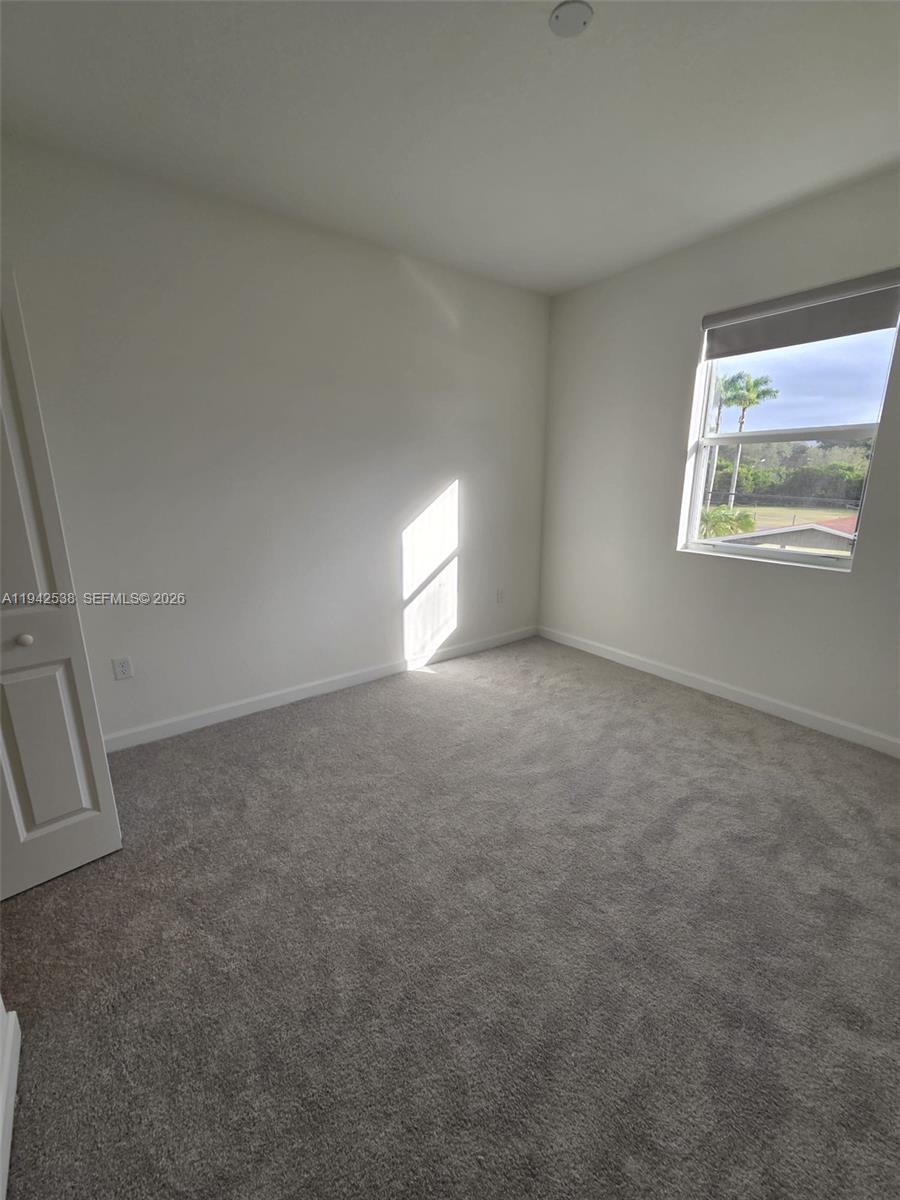 16303 Southwest 147th Place, Unit 16303 Miami, FL 33193 - Photo 23 of 37 an empty room with a window