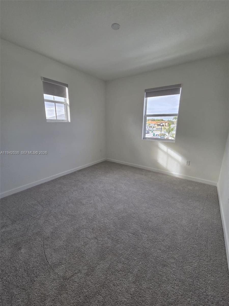 16303 Southwest 147th Place, Unit 16303 Miami, FL 33193 - Photo 26 of 37 an empty room with windows
