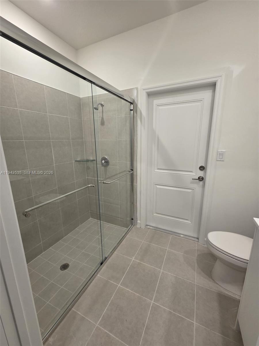 16303 Southwest 147th Place, Unit 16303 Miami, FL 33193 - Photo 37 of 37 a bathroom with a shower and a toilet
