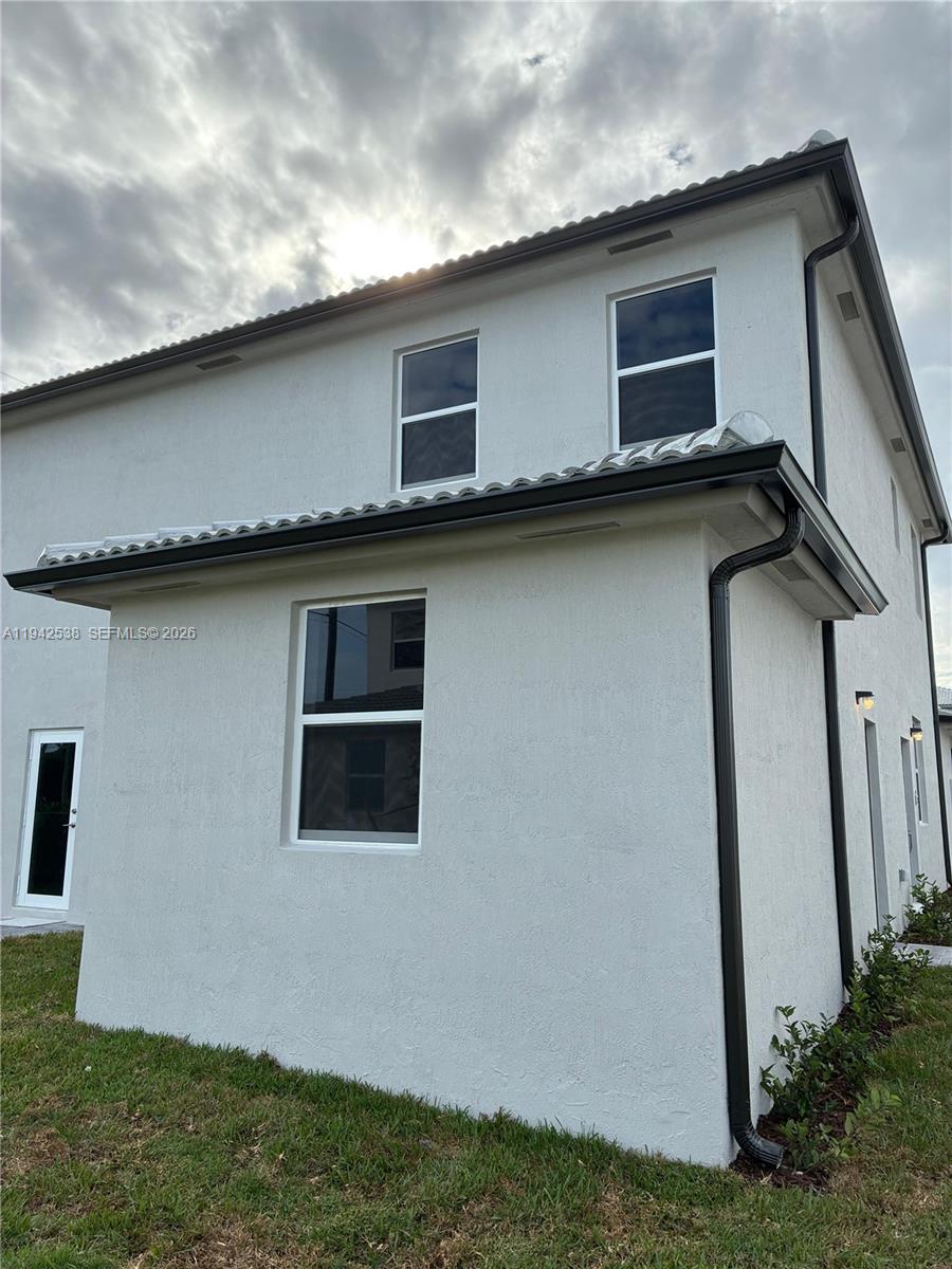 16303 Southwest 147th Place, Unit 16303 Miami, FL 33193 - Photo 4 of 37 a house view with a backyard space