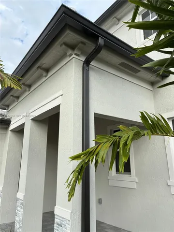 a view of an empty room with stairs and a window