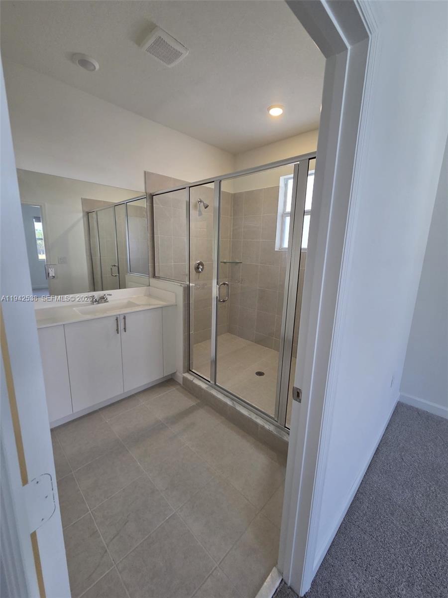 16303 Southwest 147th Place, Unit 16303 Miami, FL 33193 - Photo 9 of 37 a view of a bathroom with sink mirror and window