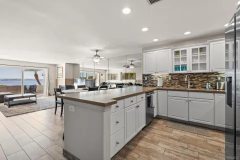 a kitchen with counter top space and windows
