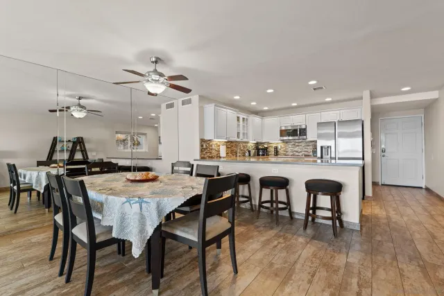 a view of a dining room with furniture and wooden floor