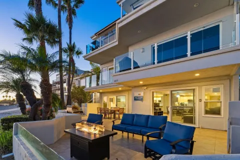 a view of a patio with couches table and chairs potted plants and palm tree