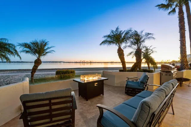 a view of a ocean with furniture