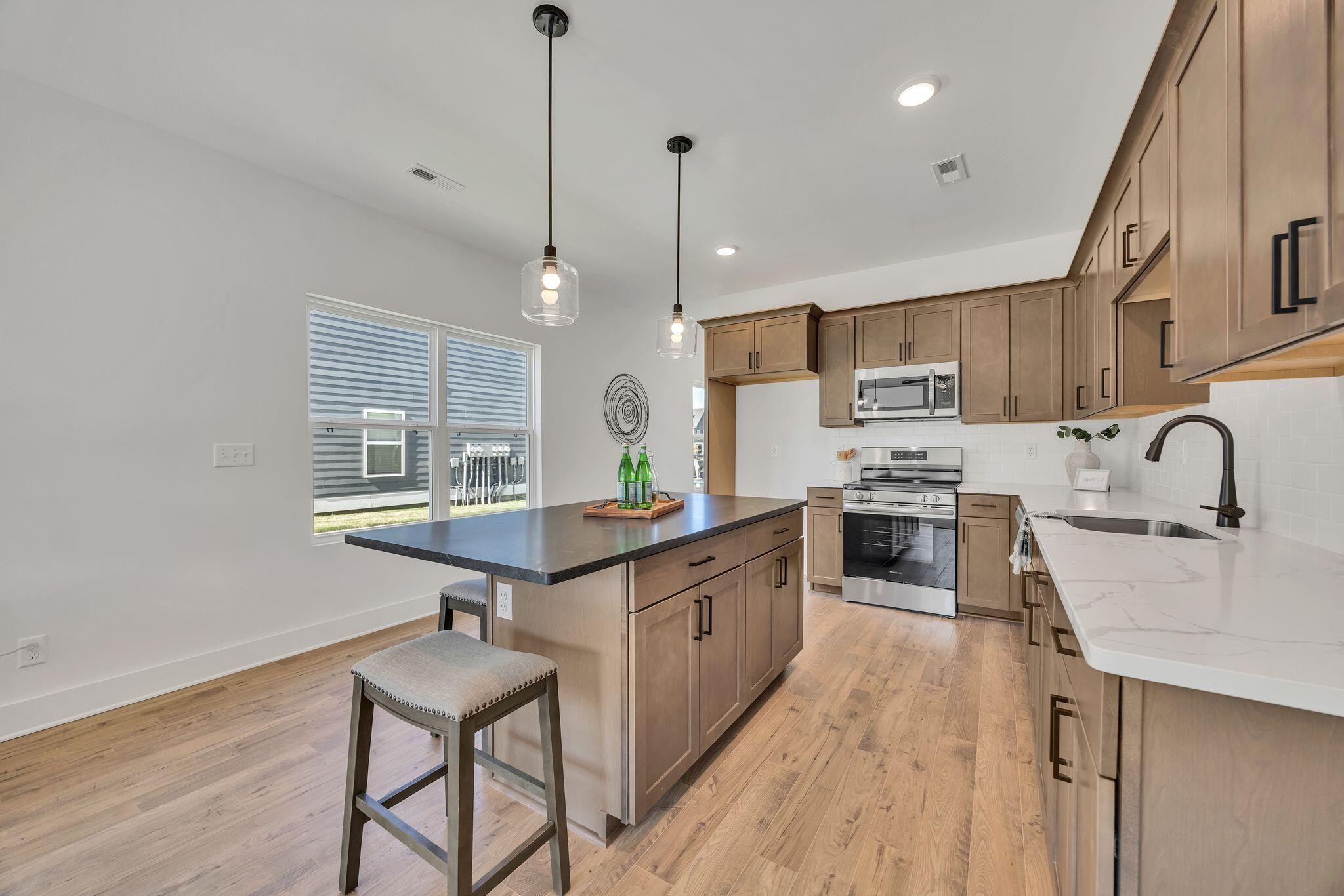 1809 Cotton Way Chattanooga, TN 37404 - Photo 8 of 27 a kitchen with stainless steel appliances granite countertop a sink stove and refrigerator