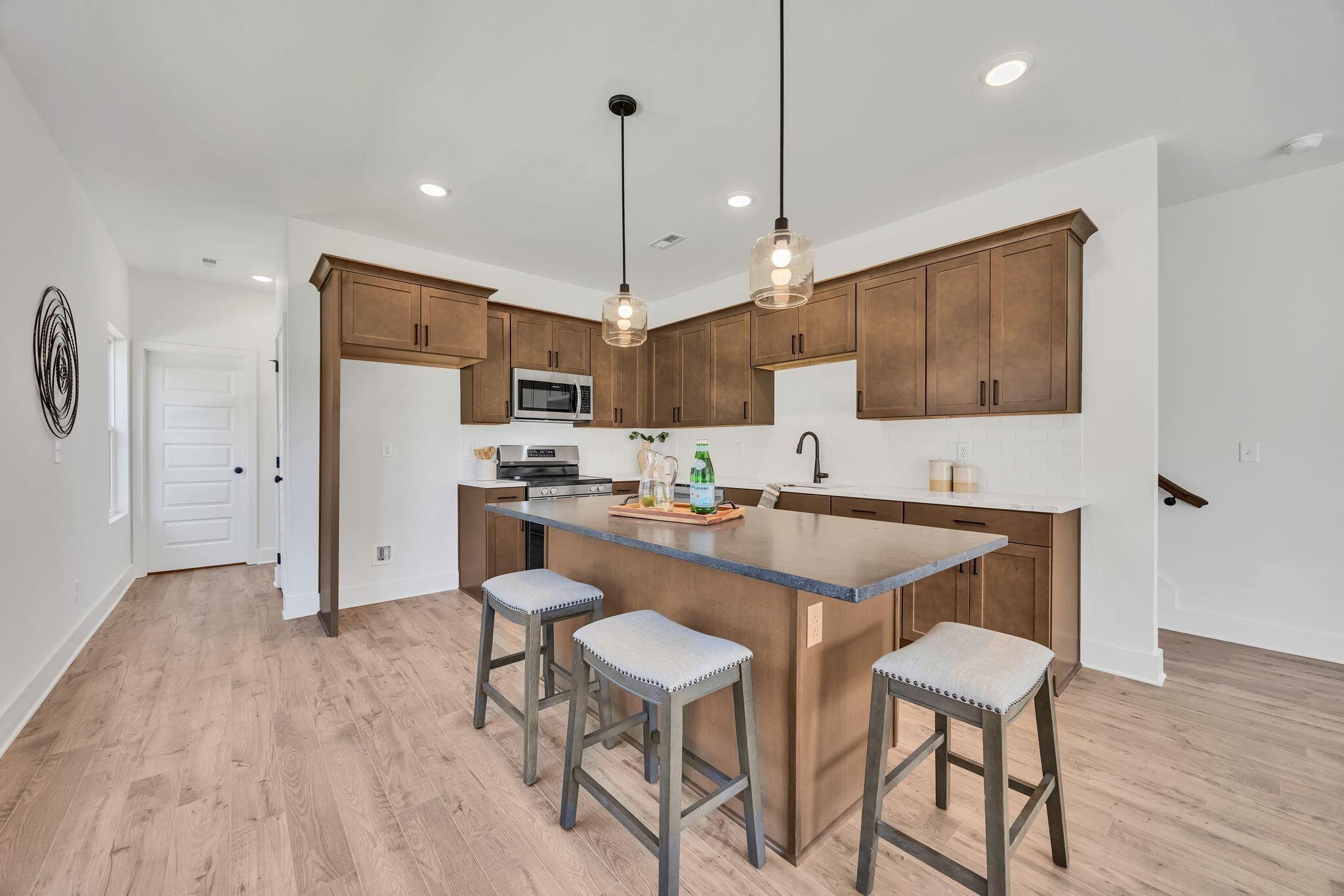 1809 Cotton Way Chattanooga, TN 37404 - Photo 9 of 27 a kitchen with kitchen island white cabinets and stainless steel appliances